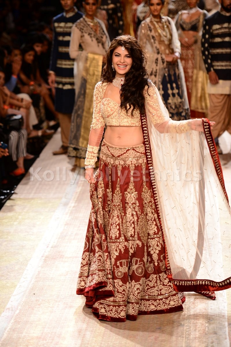 Bollywood Style Jacqualine Fernandz silk and net bridal lehenga choli in Maroon and beige color